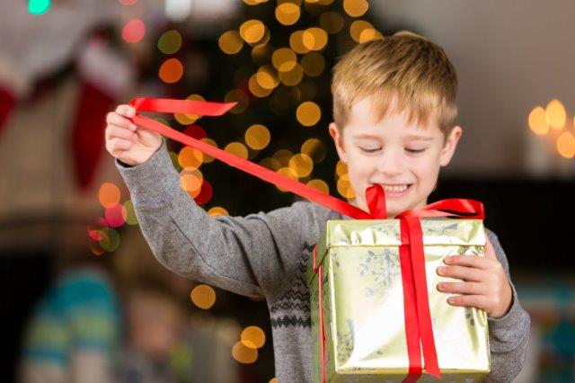 istock Young boy opening Christmas gift small version