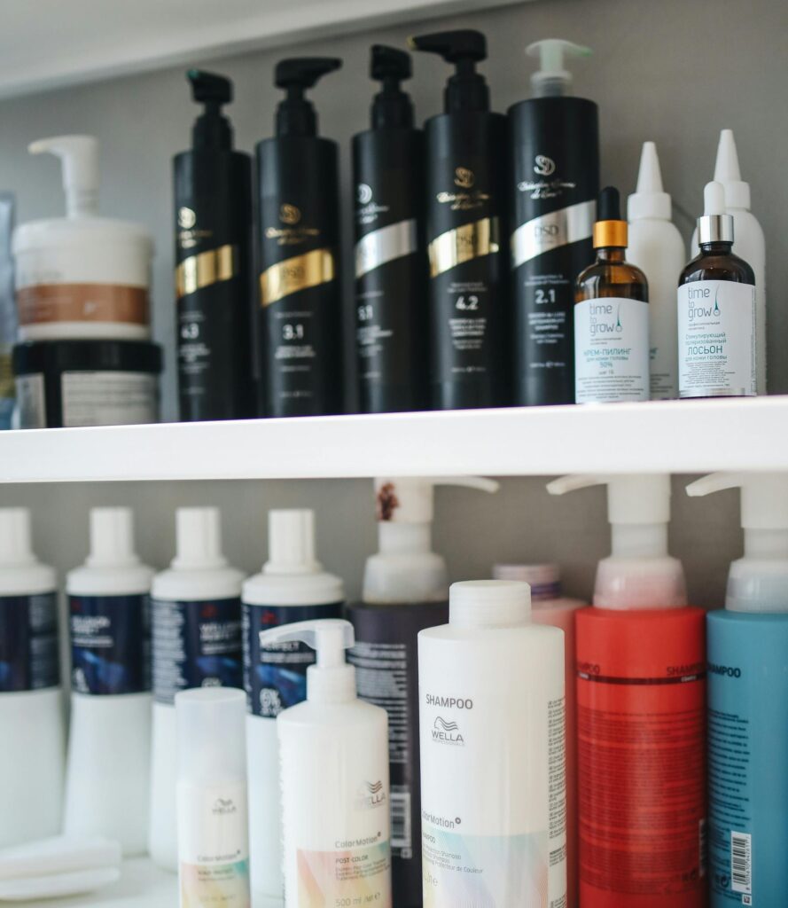 Shampoo and conditioner bottles are lined up on two shelves